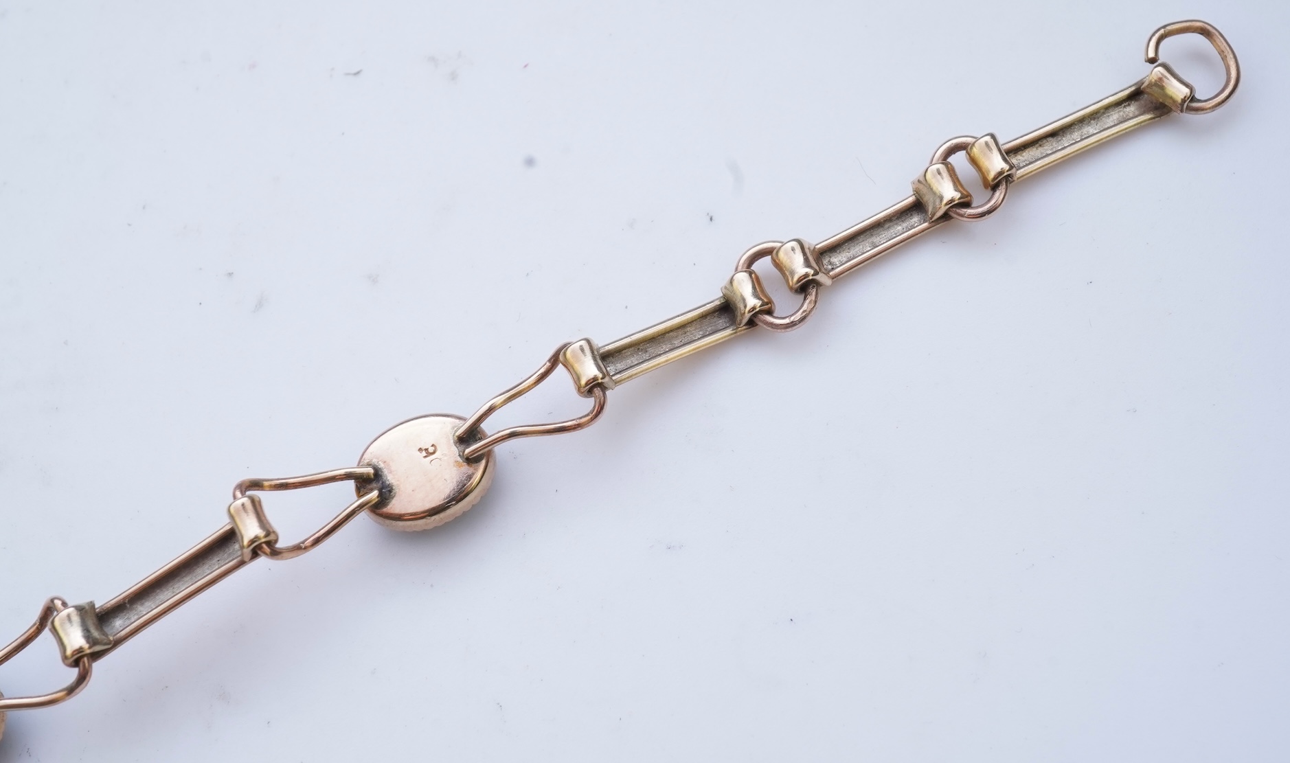 An opal triplet bracelet and pair of earrings, comprising: a gold bracelet set with opal triplets, length 18cm; and a pair of studs set with opal doublets, mounted in gold, length 0.8cm each, post fittings, stamped 585,